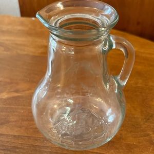 Vintage glass pitcher 6.75”H with a clipper ship embossed on the side.